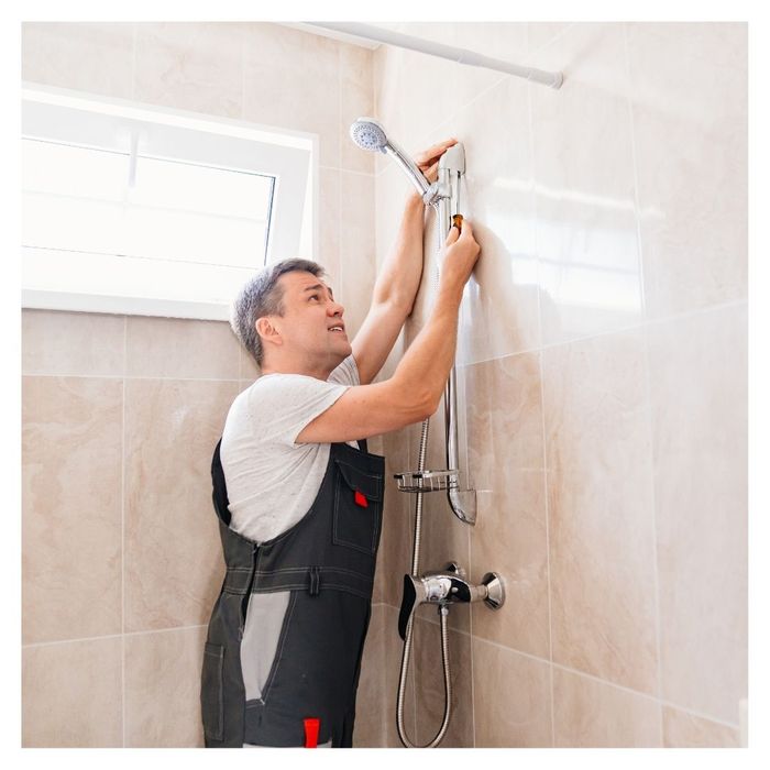 plumber fixing a shower head