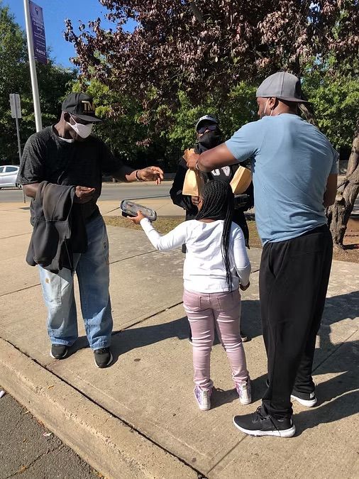 img of a man and girl handing things out img30.jpeg