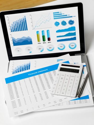 laptop with financial graphs and calculator