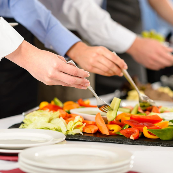 people picking food from catering dish people picking food from catering dish