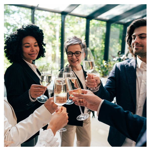 Coworkers cheering with a glass