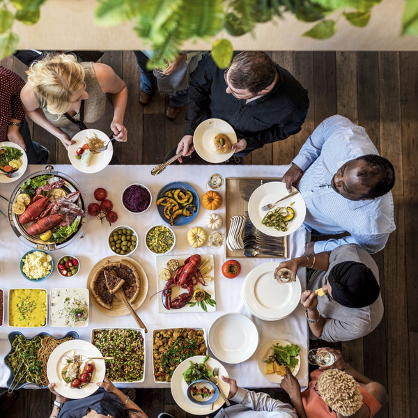 group of people at catering table serving themselves group of people at catering table serving themselves