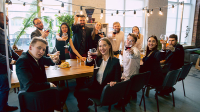 Corporate employees raising a glass to the camera