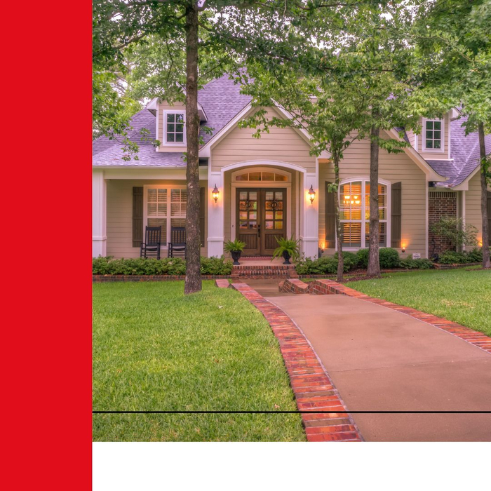 A picturesque walkway leading to the front door of a large home