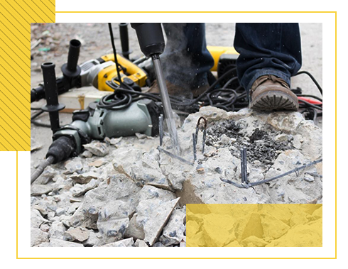 Construction worker jackhammering concrete