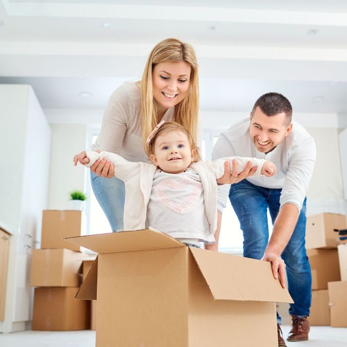 family packing boxes with baby