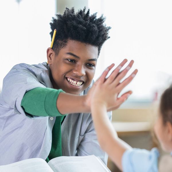 tutor high fiving student