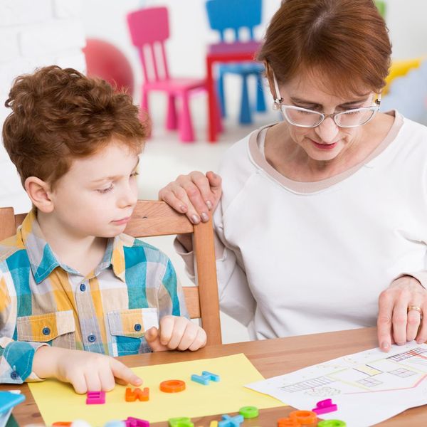 Woman teacher works with child