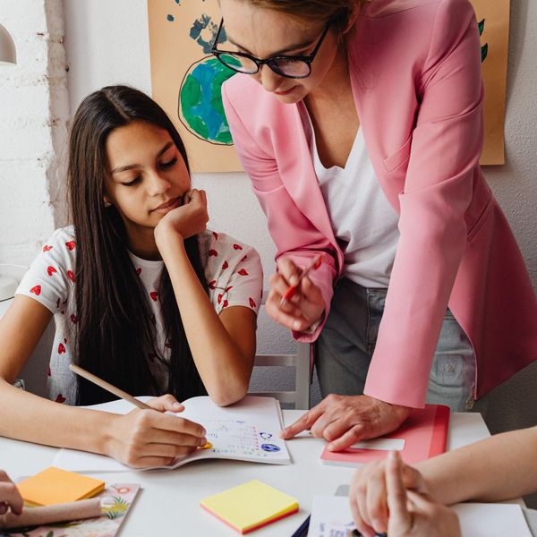 Teacher helps teen with writing