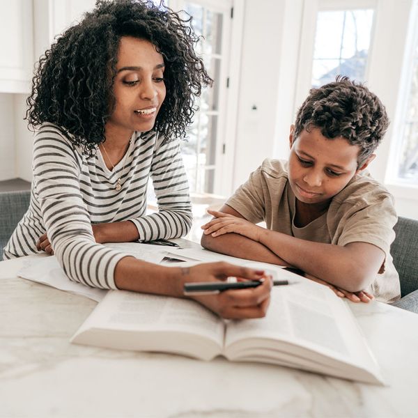 tutor with student and book