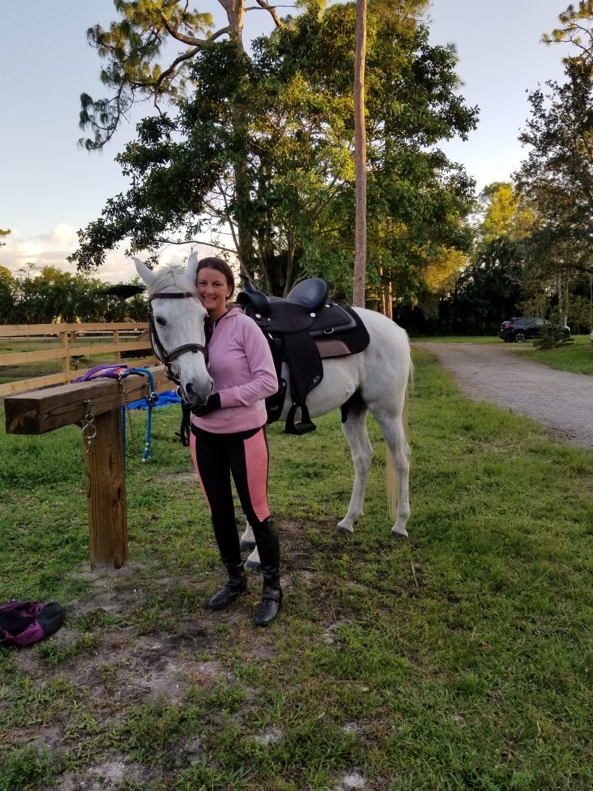 girl with a horse, looking at camera