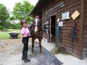 girl with a horse, looking at camera