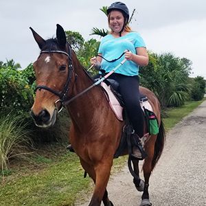 girl with a horse, looking at camera