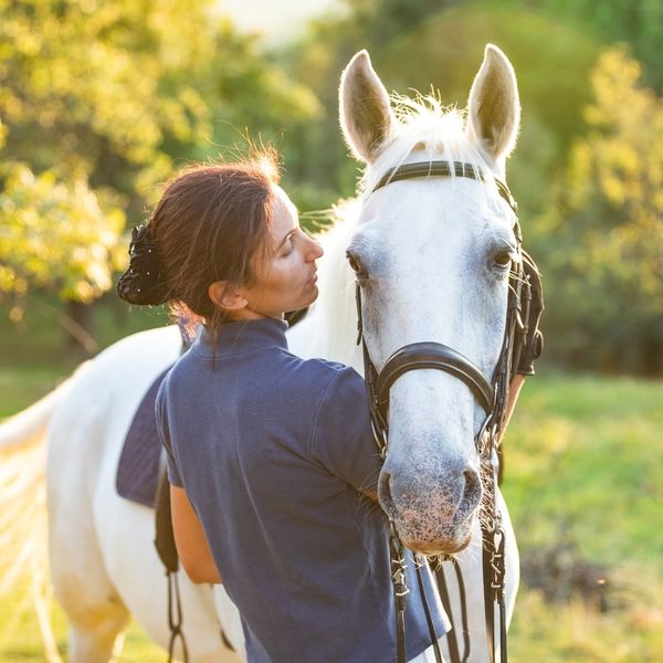 Woman bonding with her horse