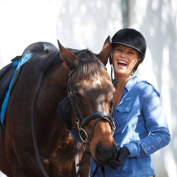 woman smiling with horse