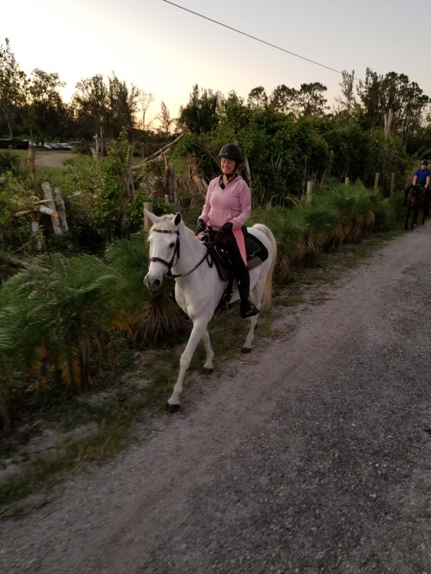 girl with a horse, looking at camera