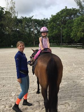 girls with a horse, looking at camera girls with a horse, looking at camera