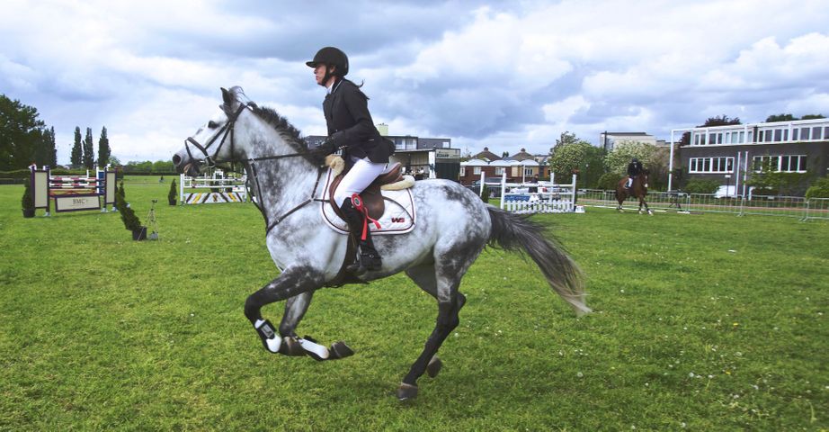 woman cantering on horse