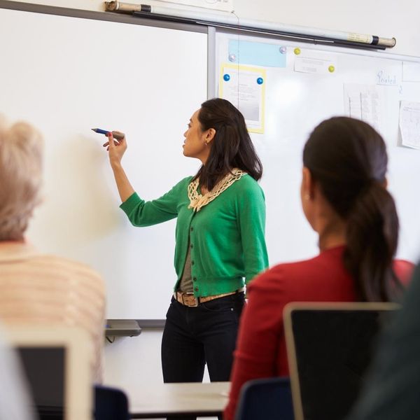 Woman teaching adults in a classroom