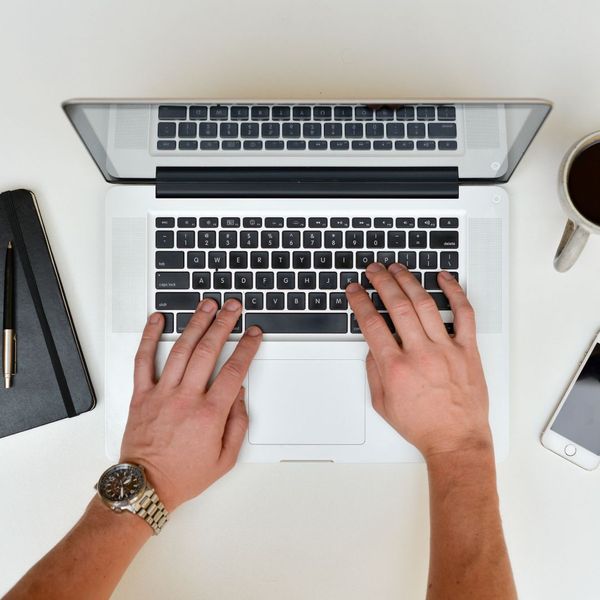 man typing on computer