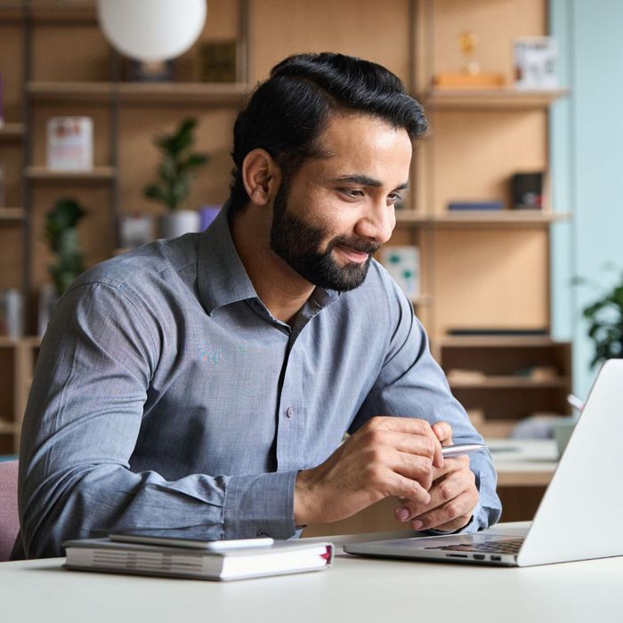 A man at home on his computer studying