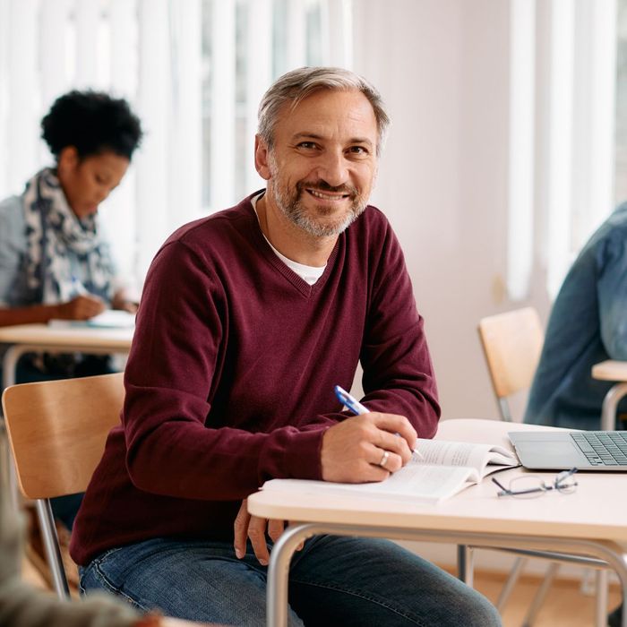 A man at a desk in class