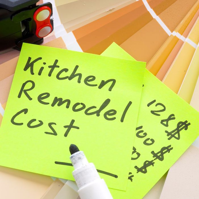 Two green sticky notes, one with the words "kitchen remodel cost" written on it. 