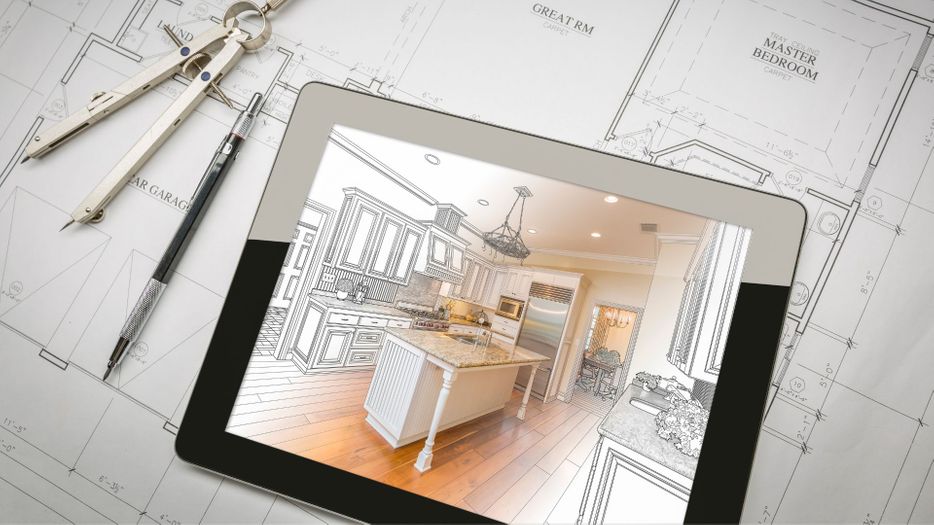 Tablet with a picture of a plan for kitchen remodeling on top of blueprints. 