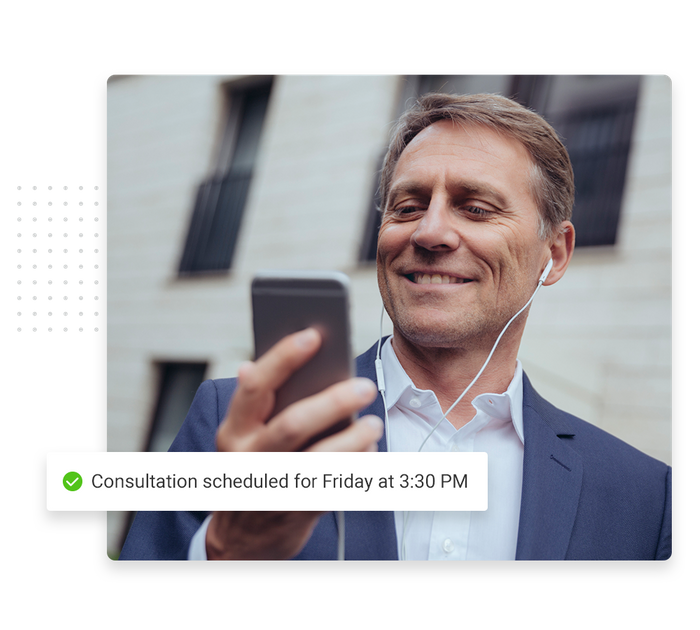 Man wearing headphones, looking at phone overlaid with a checkmark that says 'Consultation scheduled for Friday at 3:30 PM' Consultant scheduling software
