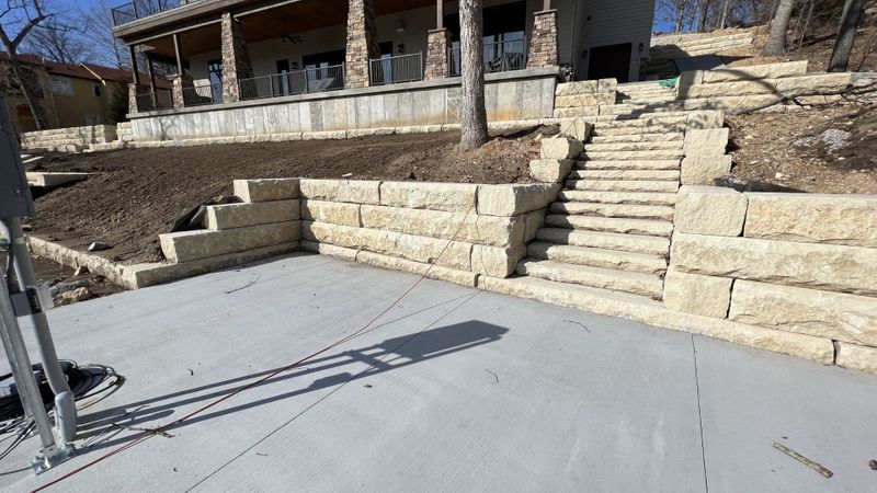 home with rock steps and a retaining wall