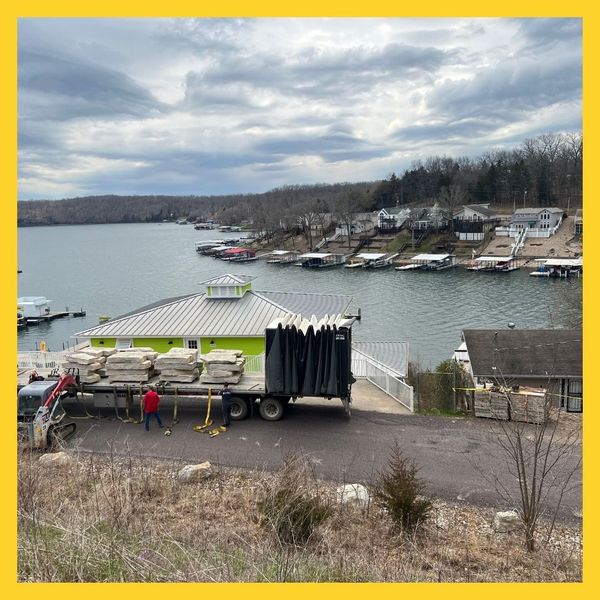 overlooking lake, boats, truck with stone slabs on flatbed