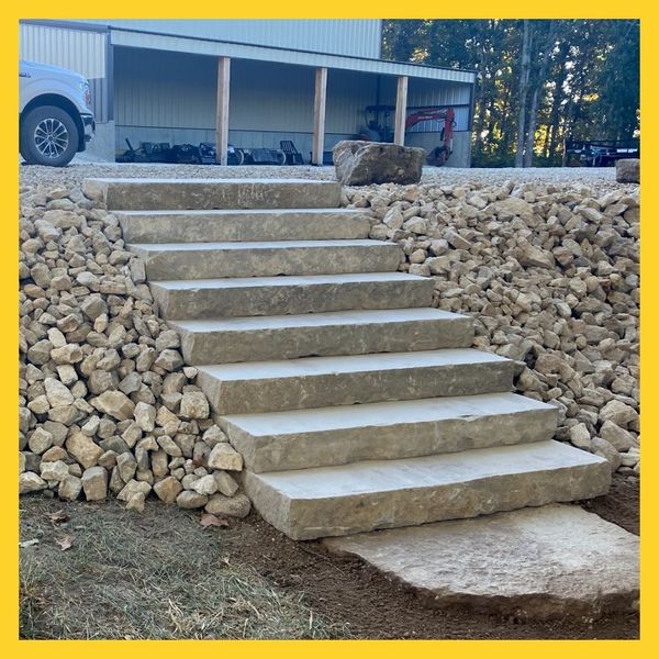 river rocks surrounding stone slab stairs