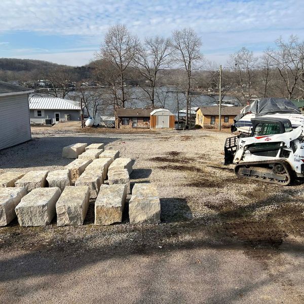 large limestone blocks staged at a job site near the lake, demonstrating our ability to deliver wholesale rock to difficult locations.