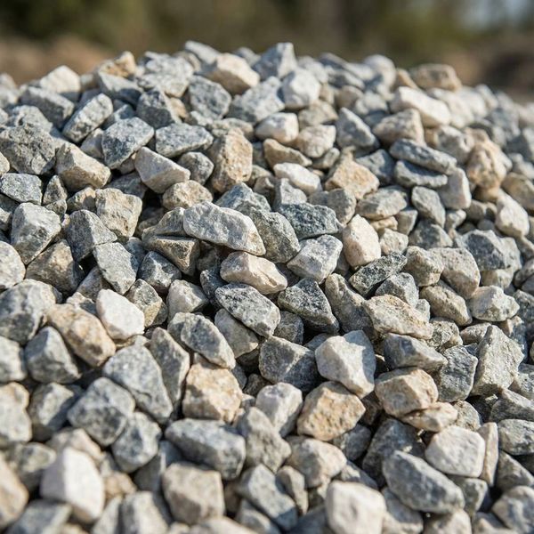 Close-up texture of angular crushed limestone, a superior wholesale rock option for creating a locking, stable base.