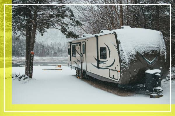two-behind RV at a snowy lake