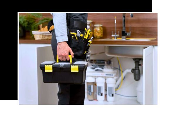 A home plumber holding a toolbox.