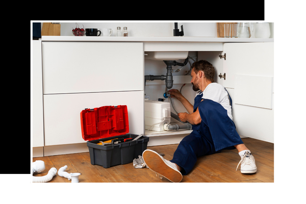 plumber working on leaky sink