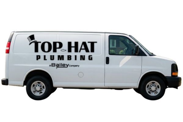 White van with Top Hat Plumbing logo