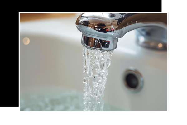 Faucet in sink with running water coming out
