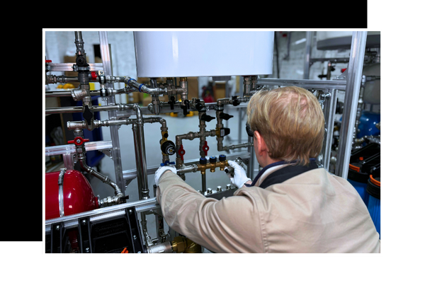 A plumber working on a water heater.
