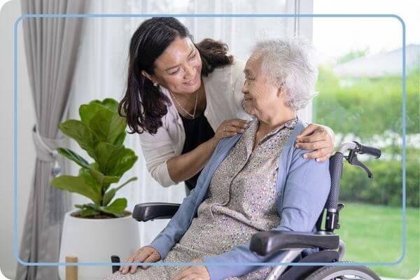 caregiver with woman in wheelchair