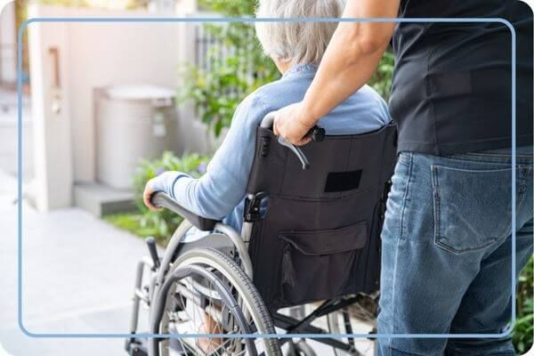 woman in wheel chair being pushed woman in wheel chair being pushed