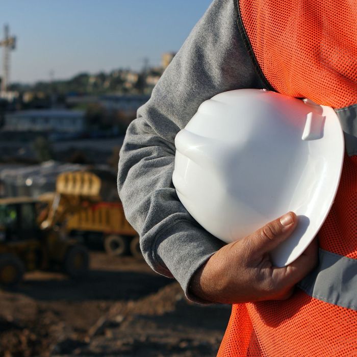 person holding hard hat