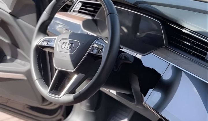Clean interior view of a vehicle focusing on the steering wheel and dashboard.
