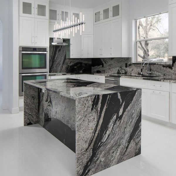 white kitchen cabinets with a granite backsplash and a granite island