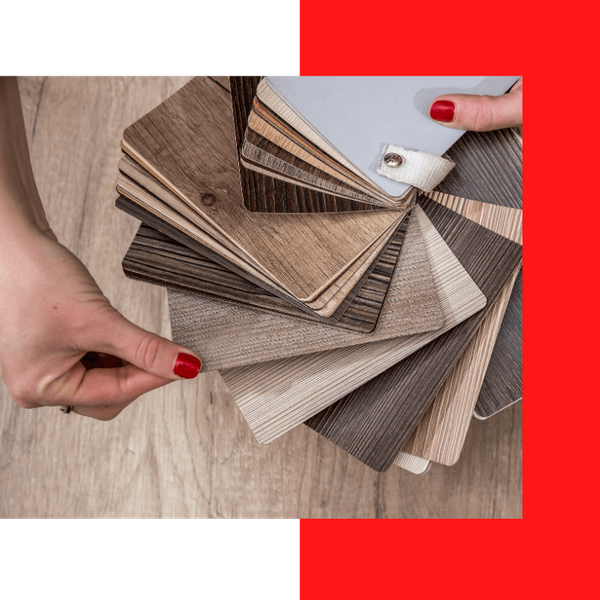 a person looking through a sample book of vinyl textures