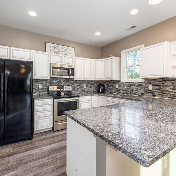 granite countertop and white cabinets