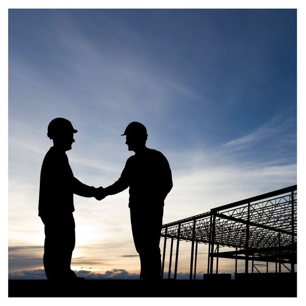 Two workers shaking hands