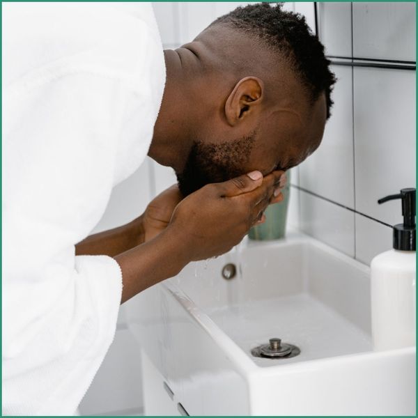 Man washing his face