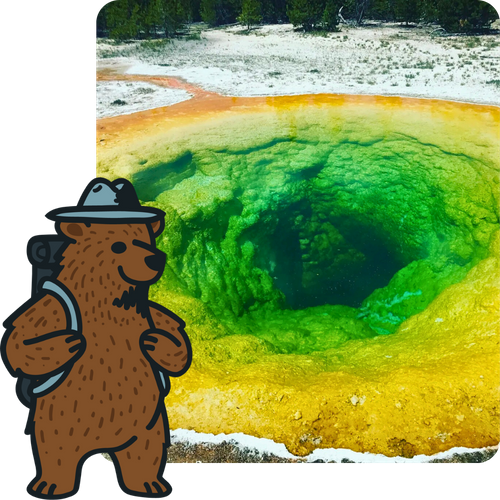A vibrant thermal pool with bright green and yellow rings of color. A cartoon brown bear wearing a ranger hat and backpack is superimposed in the bottom left corner.